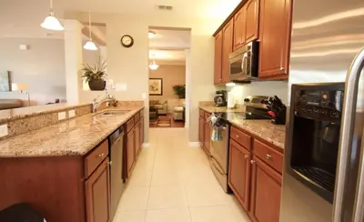 a kitchen with wooden cabinets and a counter top at Cayview Condo #231536 in Orlando