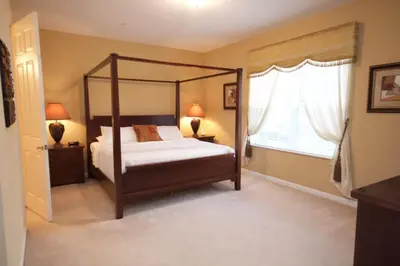 a bedroom with a canopy bed and a window at Cayview House #231539 in Orlando