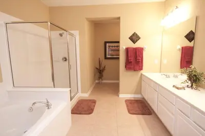 a large bathroom with two sinks and a shower at Cayview House #231539 in Orlando