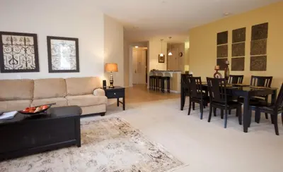 a living room with a couch and a dining room at Cayview House #231539 in Orlando