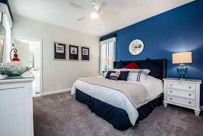 a blue bedroom with a bed and a blue wall at King Castle Villa #230920 in Kissimmee