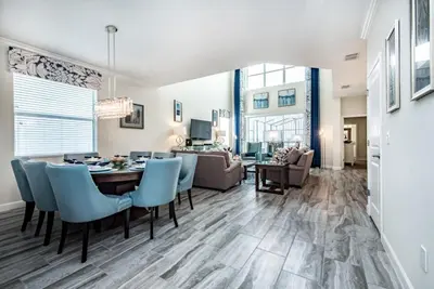 a dining room and living room with a table and chairs at King Castle Villa #230920 in Kissimmee
