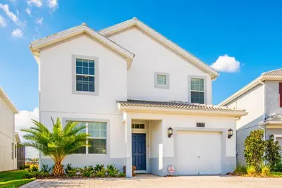 a white house with a garage at King Castle Villa #230920 in Kissimmee