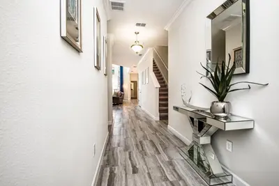 a hallway of a home with a console table and a mirror at King Castle Villa #230920 in Kissimmee