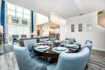 a dining room with a table and blue chairs at King Castle Villa #230920 in Kissimmee