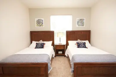 a bedroom with two beds and a window at Shoreway House #231523 in Orlando