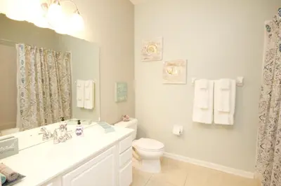 a white bathroom with a sink and a toilet at Shoreway House #231523 in Orlando