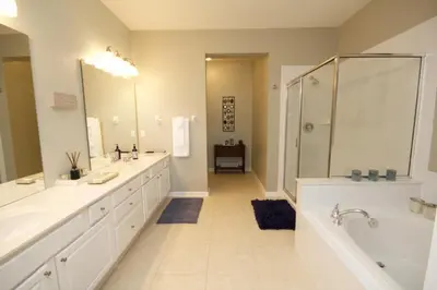 a large bathroom with two sinks and a shower at Shoreway House #231523 in Orlando