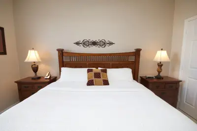 a bedroom with a large white bed with two lamps at CayView Condo #231544 in Orlando