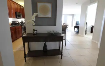 a kitchen with a table with a vase of flowers on it at Cayview Condo #231541 in Orlando