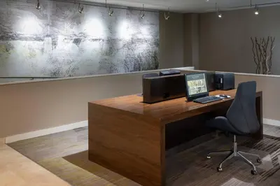 an office with a desk with a computer on it at Courtyard by Marriott Orlando Airport in Orlando