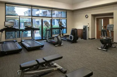 a gym with cardio equipment in a hotel room at Courtyard by Marriott Orlando Airport in Orlando