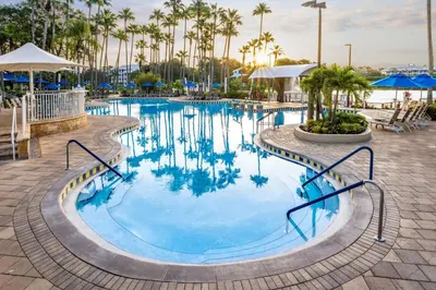 a swimming pool at a resort with palm trees at Marriott's Cypress Harbour Villas in Orlando