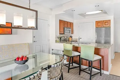 a kitchen with a glass table and chairs at Marriott's Grande Vista in Orlando