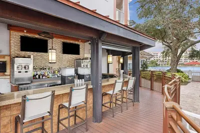 a bar with white chairs on a wooden deck at Marriott's Grande Vista in Orlando