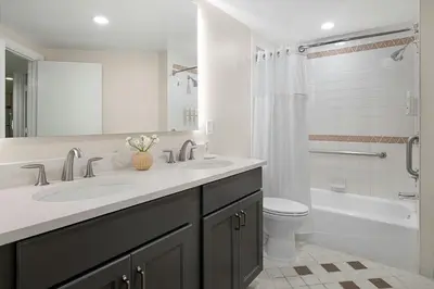 a white bathroom with two sinks and a toilet at Marriott's Imperial Palms Villas in Orlando