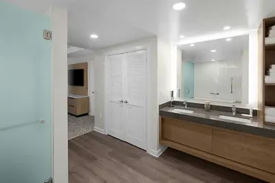a bathroom with two sinks and a large mirror at Marriott's Imperial Palms Villas in Orlando