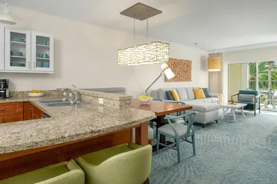 a kitchen and living room with a table and chairs at Marriott's Harbour Lake in Orlando
