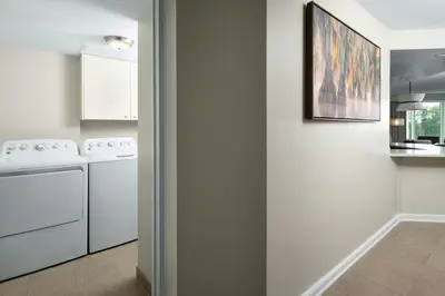 a kitchen with white appliances and a painting on the wall at Marriott's Royal Palms in Orlando