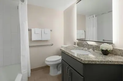 a white bathroom with a toilet and a sink at Marriott's Royal Palms in Orlando