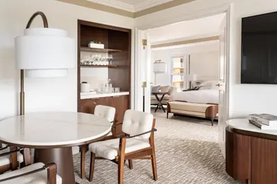 a living room with a table and a bedroom at The Ritz-Carlton Orlando, Grande Lakes in Orlando