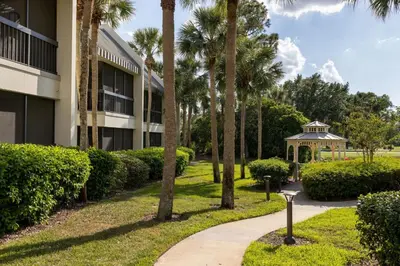 a walkway in front of a building with palm trees at Marriott's Sabal Palms in Orlando