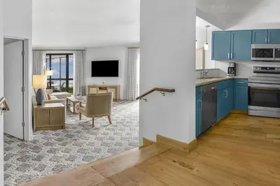 a kitchen with blue cabinets and a living room at Marriott's Sabal Palms in Orlando