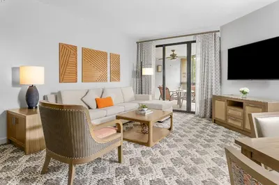 a living room with a white couch and a tv at Marriott's Sabal Palms in Orlando