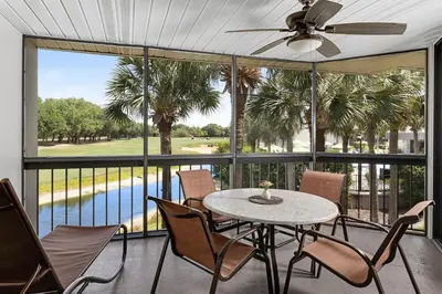 a screened in porch with a table and chairs at Marriott's Sabal Palms in Orlando