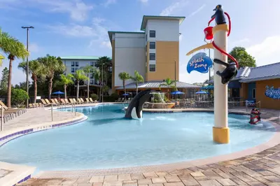 a pool at a resort with a slide at SpringHill Suites by Marriott Orlando at SeaWorld in Orlando