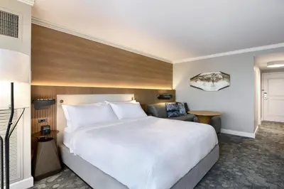 a hotel room with a large bed and a chair at JW Marriott Orlando Grande Lakes in Orlando