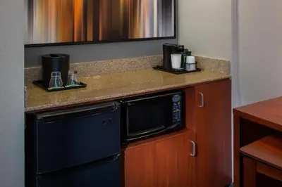 a kitchen with a black microwave on a counter at Courtyard Orlando International Drive/Convention Center in Orlando