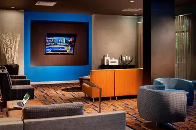 a lobby with a waiting room with blue walls and chairs at Courtyard by Marriott Orlando Lake Buena Vista in the Marriott Village in Orlando