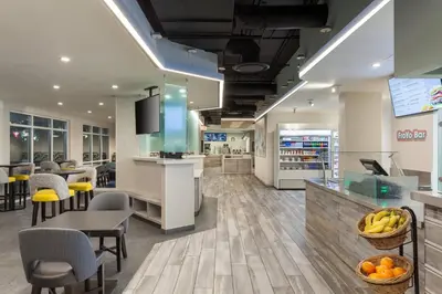 a lobby of a store with tables and chairs at SpringHill Suites by Marriott Orlando Lake Buena Vista in Marriott Village in Orlando