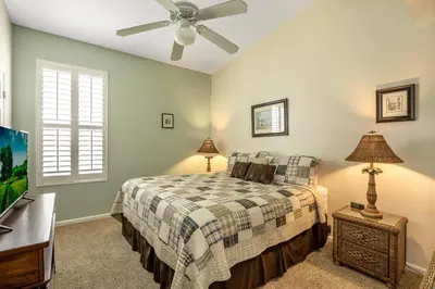 a bedroom with a bed and a ceiling fan at Sun Palm Disney Villa in Kissimmee