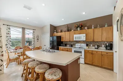 a kitchen with a large island with a counter top at Sun Palm Disney Villa in Kissimmee