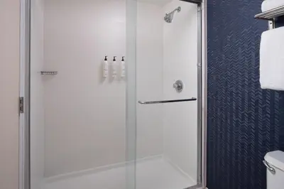 a shower with a glass door in a bathroom at Fairfield Inn Orlando Airport in Orlando