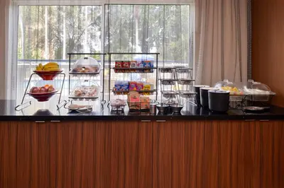 a buffet with food on a counter in a room at Fairfield Inn Orlando Airport in Orlando