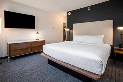 a hotel room with a bed and a flat screen tv at Courtyard Orlando Altamonte Springs Maitland in Orlando