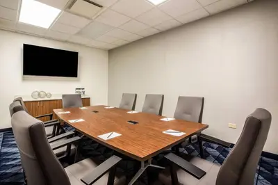 a conference room with a large wooden table and chairs at Courtyard Orlando Altamonte Springs Maitland in Orlando