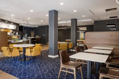 a restaurant with tables and chairs and a counter at Courtyard Orlando Altamonte Springs Maitland in Orlando
