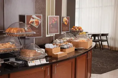 a buffet with bread and pastries on a table at SpringHill Suites Orlando Airport in Orlando
