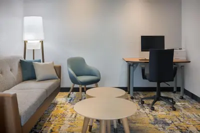 a living room with a couch and a desk with a computer at TownePlace Suites by Marriott Orlando East/UCF Area in Orlando