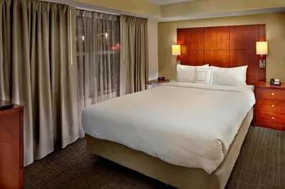 a hotel room with a large bed and a window at Residence Inn Orlando Lake Mary in Lake Mary