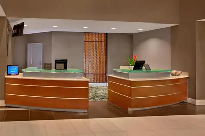 a lobby with two counters with computers on them at Residence Inn Orlando Lake Mary in Lake Mary