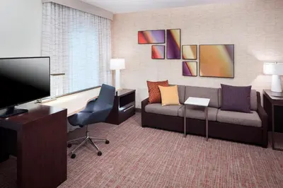a living room with a couch and a tv at Residence Inn by Marriott Near Universal Orlando in Orlando