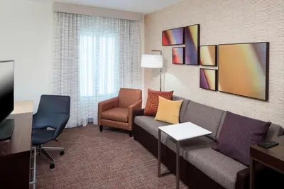 a living room with a couch and a chair at Residence Inn by Marriott Near Universal Orlando in Orlando