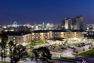 a city at night with cars parked in a parking lot at Residence Inn by Marriott Near Universal Orlando in Orlando