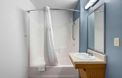 a bathroom with a shower curtain and a sink at Extended Stay America Select Suites - Orlando - South in Orlando