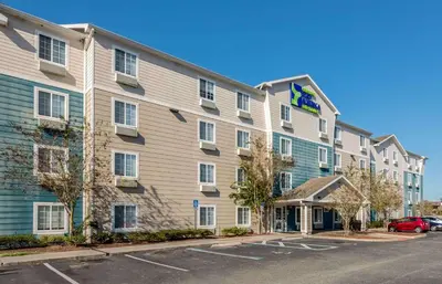 a rendering of a hotel with a parking lot at Extended Stay America Select Suites - Orlando - East in Orlando